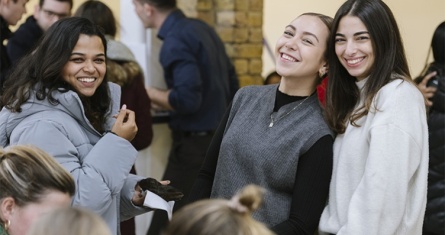 3 smiling female students